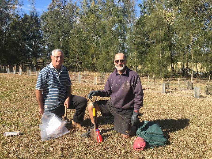 STATION: Shoalhaven Landcare  volunteers Ron Cowlishaw and Frank Neri establishing a fox control station at Cambewarra.
