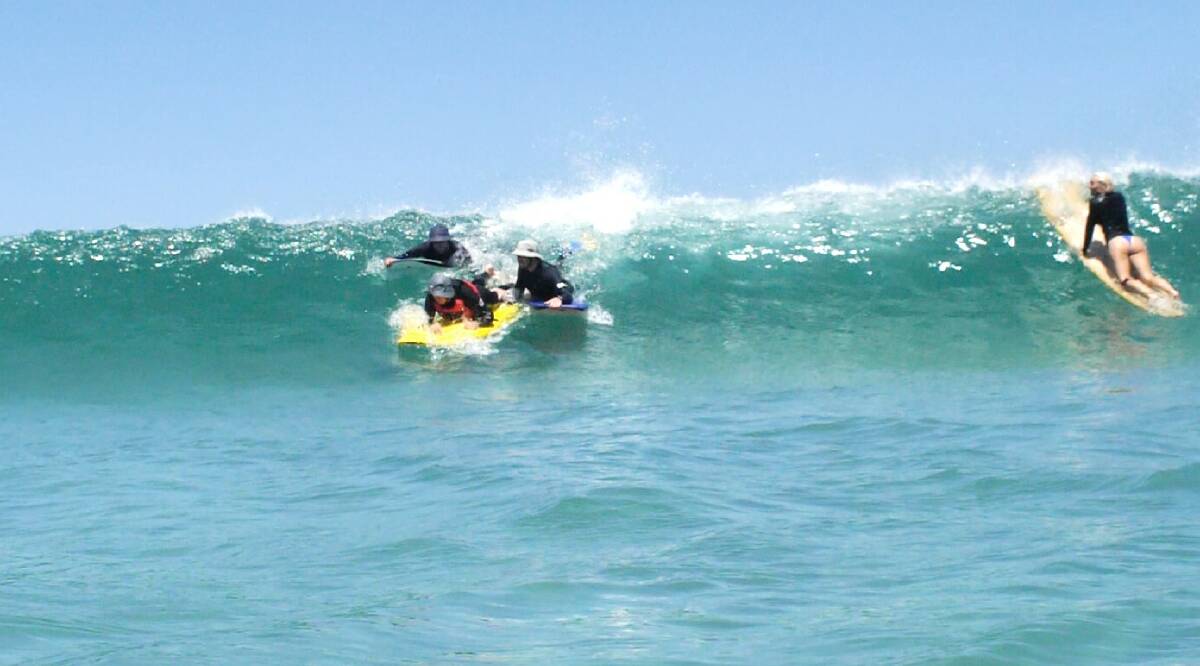 GO: James Gissing (left) and Russ Quinn launch Steve Preston onto a wave. Image: James Kates