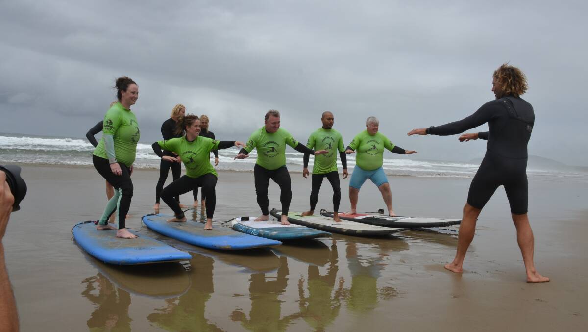 Rusty Moran takes veterans on their first surfing experience as part of the Veterans Surfing Program.
