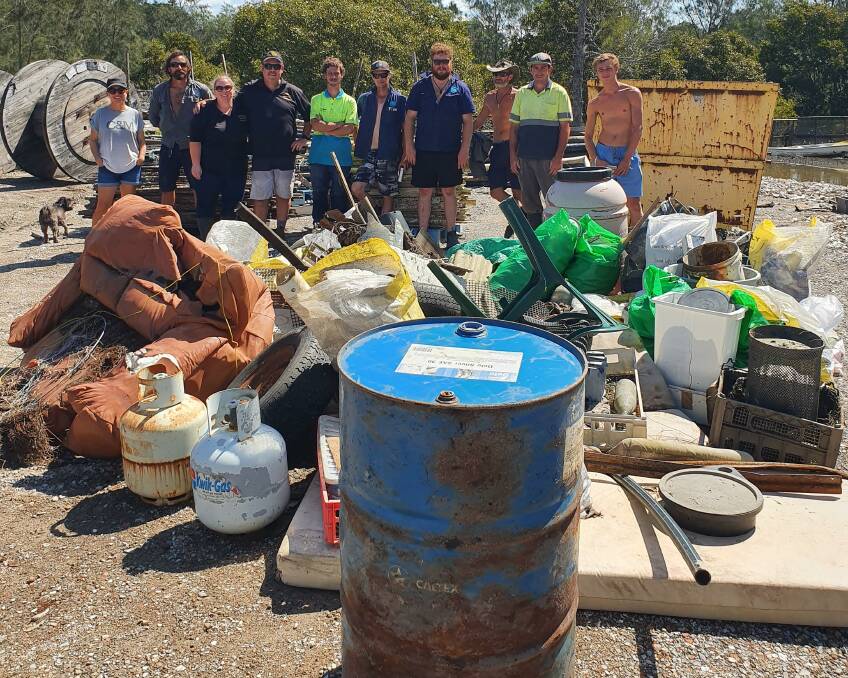 BIG HAUL: Shoalhaven oyster farmers with some of the mountain of rubbish removed from the Shoalhaven River in 2020.