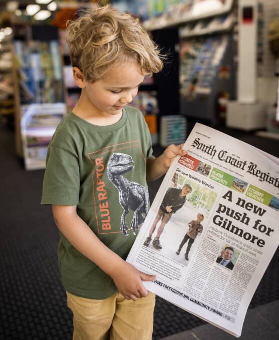 WOW: Bomaderry youngster Louie Tagg checks out his appearance on the South Coast Registry front page. Image: Rachael Tagg Photography