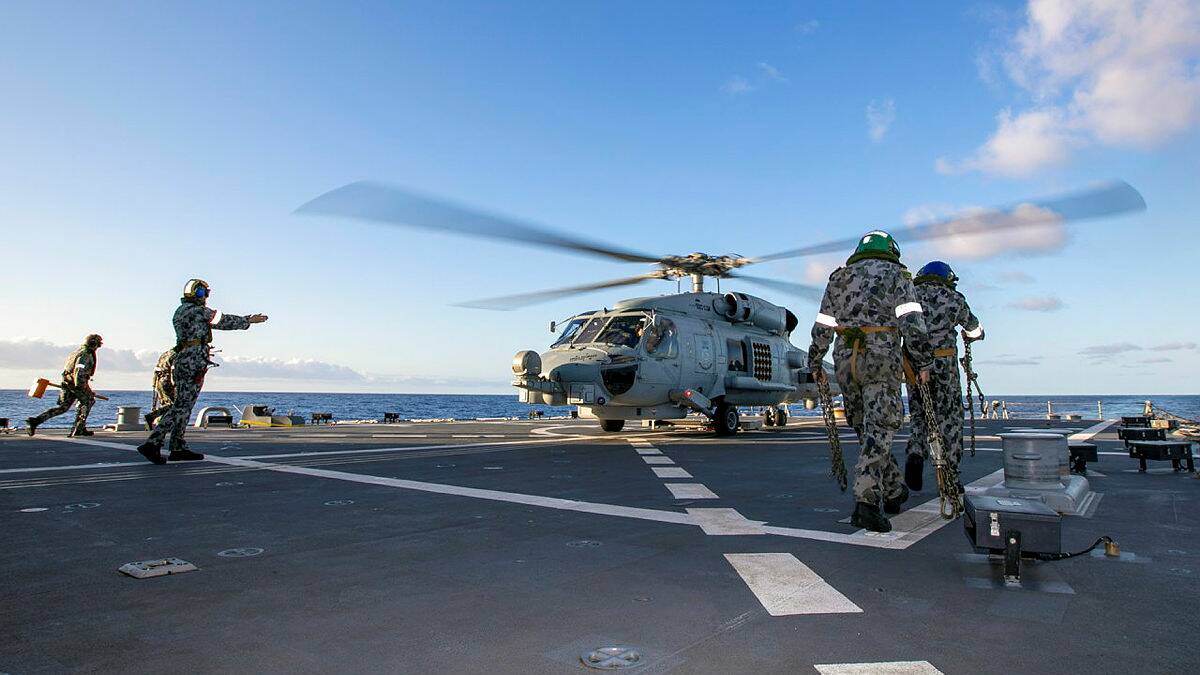 
ACTION: HMAS Albatross 816 Squadron flight crew embarked on HMAS Hobart conduct flying exercises off the coast of Hawaii, during Exercise Rim of the Pacific 2020.
