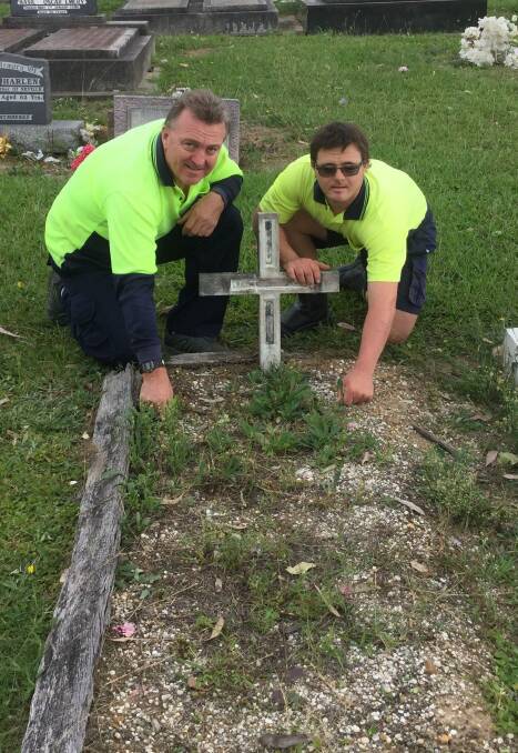 Nowra RSL Sub-Branch secretary Rick Meehan and his son Luke start work on repairing Private Raymond Benson’s grave in the Nowra General Cemetery.
