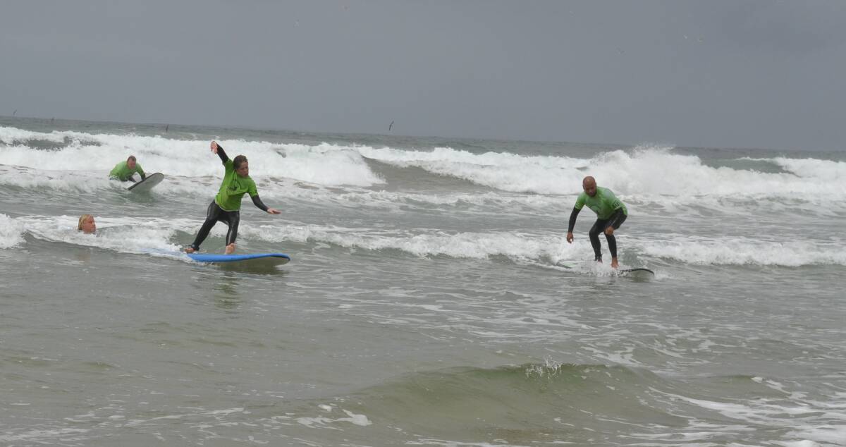 WHOO-HOO: Rebecca Machelski and a fellow participant in the first Veterans Surfing Program get up on their boards.
