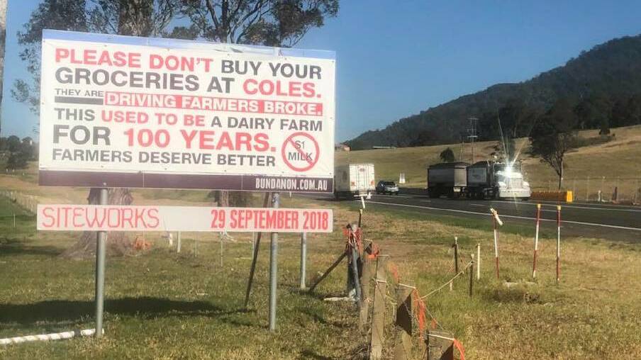 MESSAGE: The Cochrane family erected a sign on their Princes HIghway property at Meroo in September condemning Coles'  $1 a litre milk.
 
