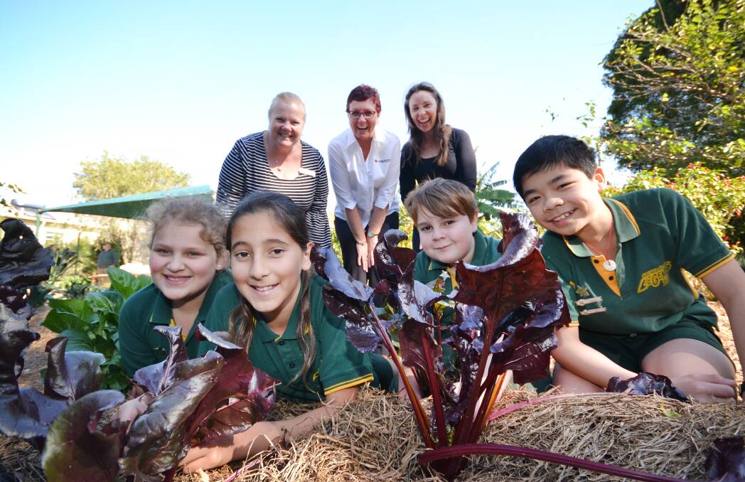 COMMUNITY FIRST: Nowra East Public School students Mason Sheppard, Serena Hunter, Alisha Hybinett and Kelvin Li with Principal Kristie Goldthorp, Australian Red Cross Nowra Regional Manager Alison Murie and TAFE NSW Nowra Certificate IV Community Services student Monica Kincade.
