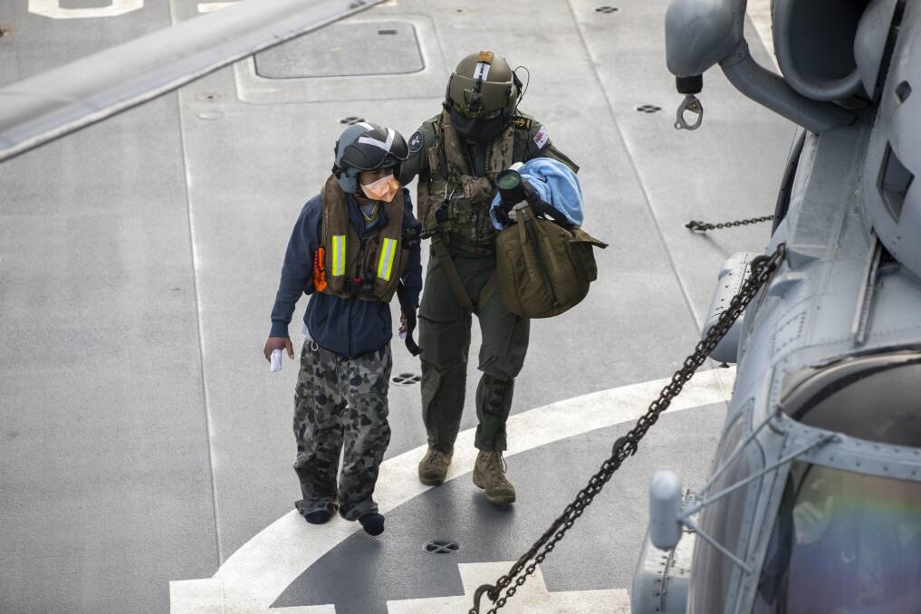 MEDICAL LIFT: An Indonesian fisherman rescued in the Indian Ocean is medically evacuated from HMAS Anzac via the ships embarked MH-60R helicopter. Photo: Thomas Sawtell