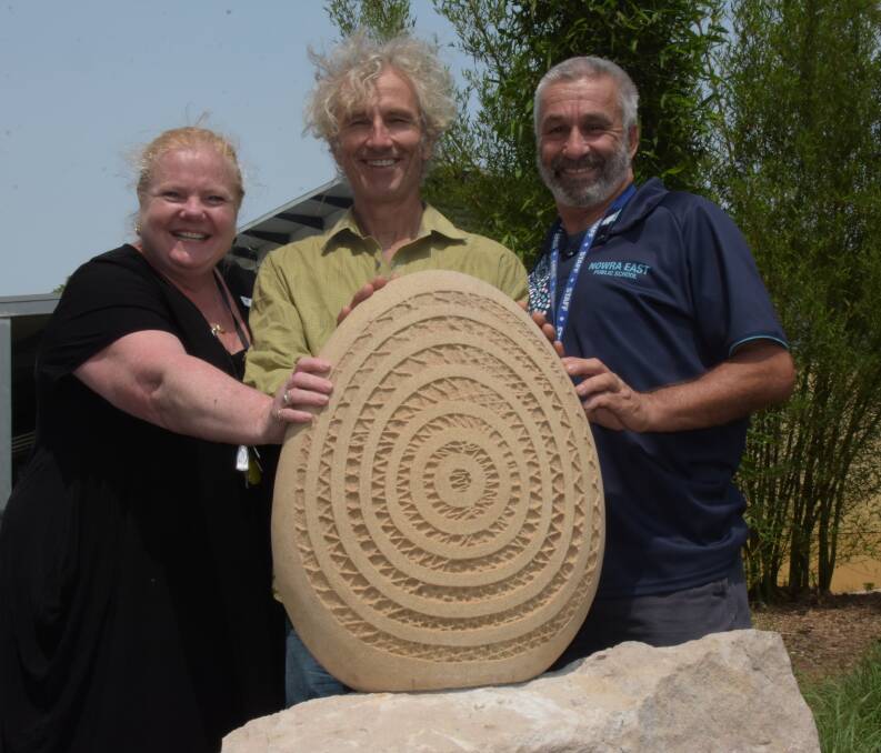 BEAUTIFUL: Brogers Creek sculptor Michael Purdy (centre) with Nowra East Public School principal Kristie Goldthorp and NEPS teacher and Community Permaculture Garden co-ordinator John Stovin-Bradford with the stunning sculpture entitled Balance.