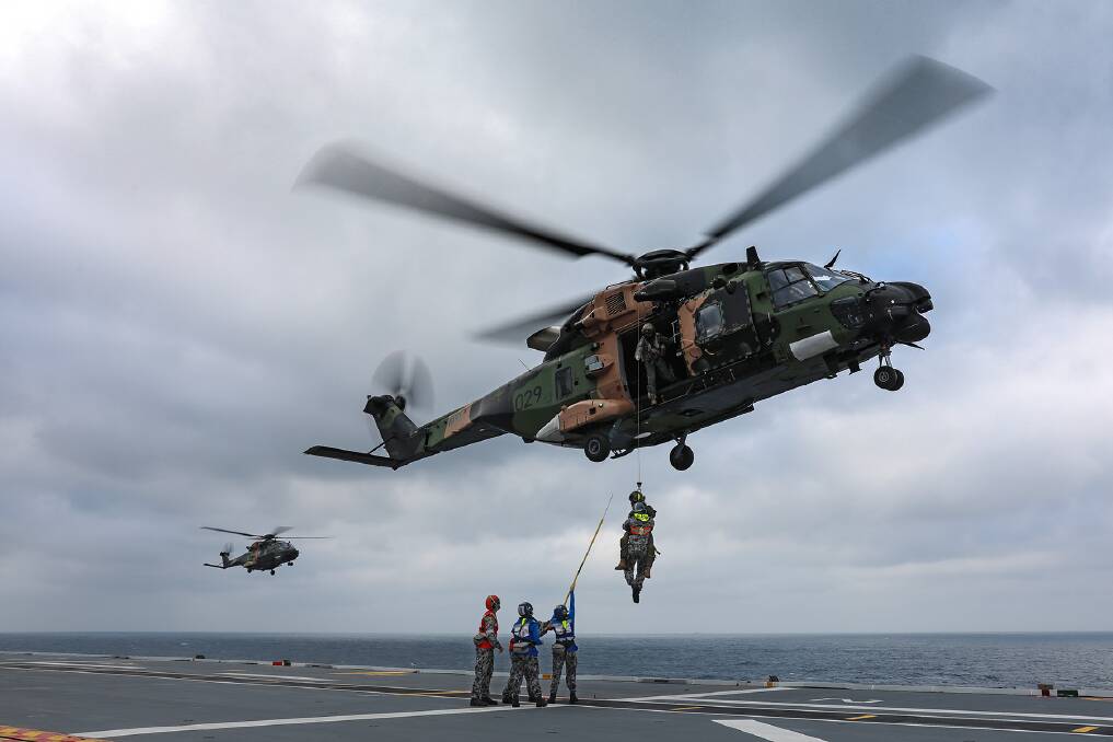 Aviation Support trainees practice winching operations with HMAS Adelaide's embarked MRH90 helicopter, Poseidon 29. Photo: Jarrod Mulvihill
