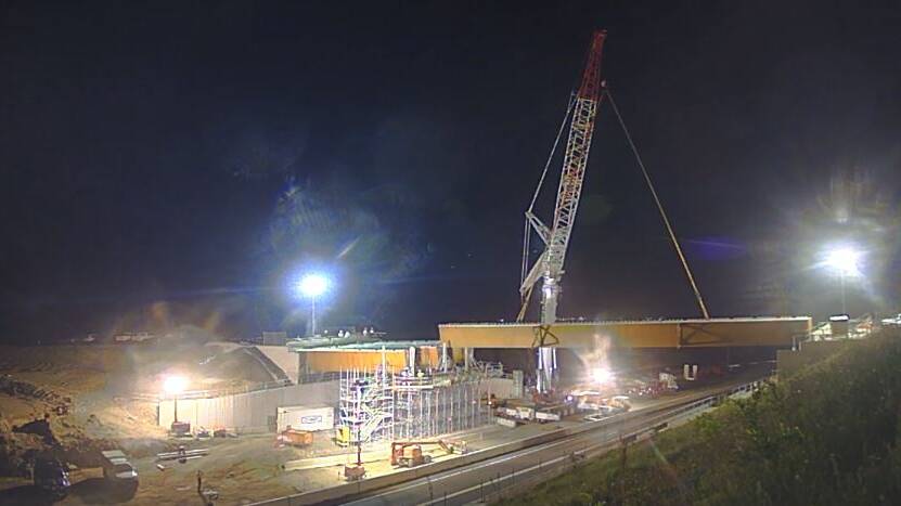 IN PLACE: One of the three girders for the Strongs Road overpass as part of the Berry to Bomaderry Princes Highway upgrade is put in place. Image: Anna Glynn