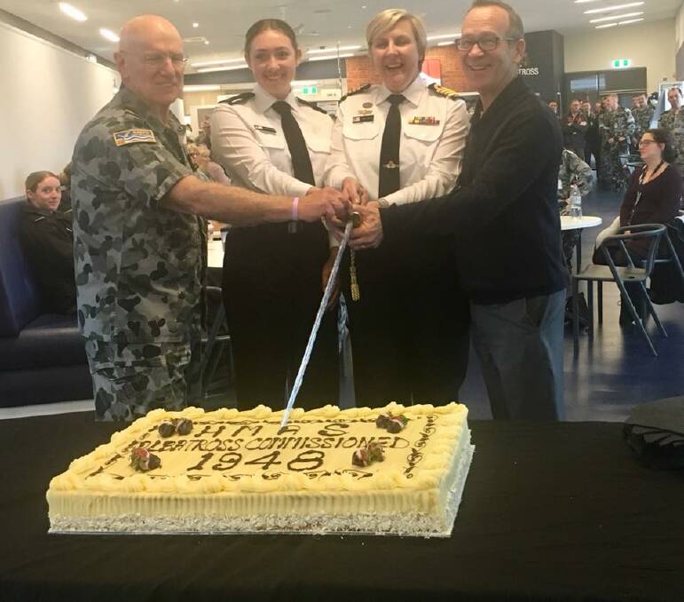 Seaman Kimberley Carter and HMAS Albatross commanding officer Captain Fiona Sneath cut the base’s 70th birthday cake with Fleet Air Arm Museum curator Terry Hetherington and one of the more senior members Lieutenant Commander Bob Kyle. Photo: Dallas McMaugh