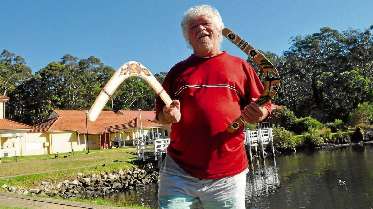 The late South Coast Aboriginal elder Laddie Timbery with some of his stunning boomerang artwork.