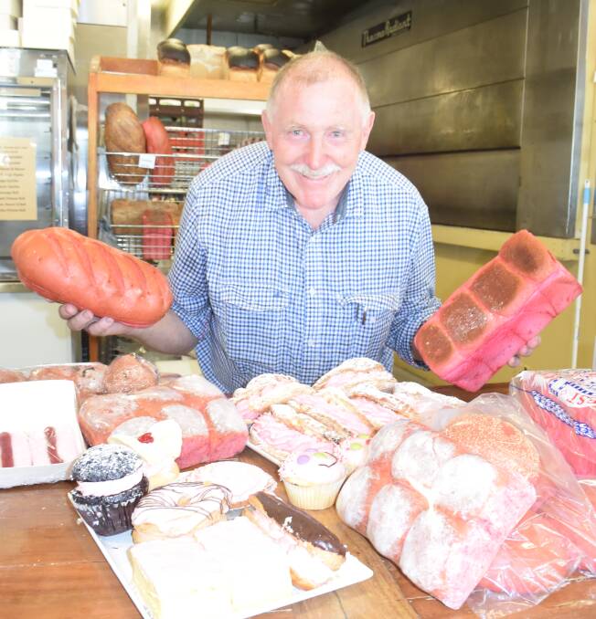 Bakehouse Delight’s John Reminis with some of the pink items produced at his bakery to celebrate his first grandchild’s arrival.