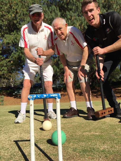 Nowra Croquet Club member Doug Houssenloge and publicity officer Bob Williamson try to explain the intricacies of the sport to South Coast Register sports editor Courtney Ward.