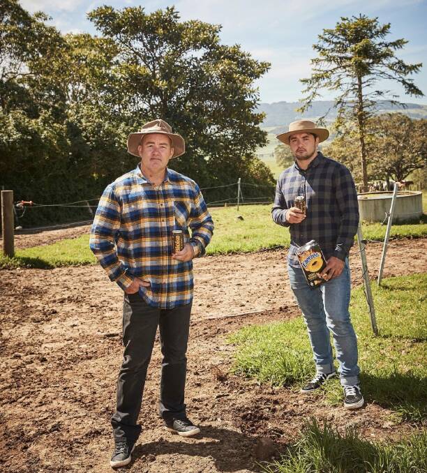 DOWN ON THE FARM: Melbourne Storm premiership winning player Brandon "The Block of Cheese" Smith (left) with Mark "Piggy" Riddell at the Condon family's Sea Breeze Holstein farm at Gerroa. Image supplied