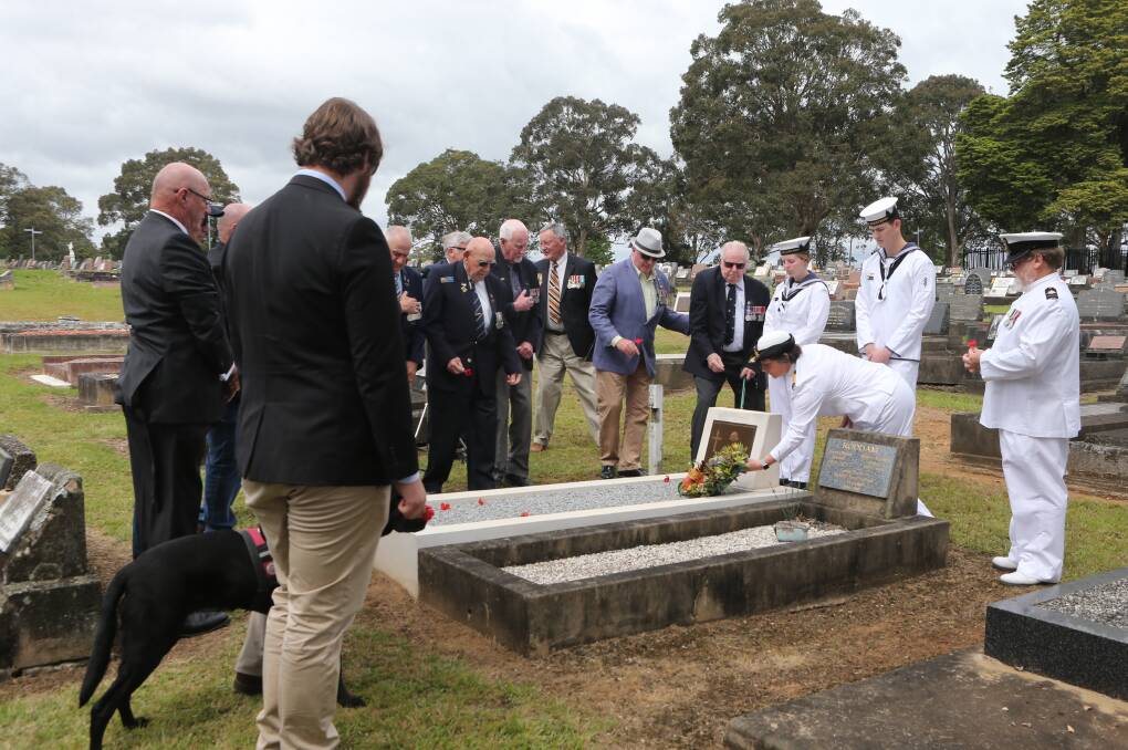 REDEDICATION: Local veterans lay poppies on the rededicated grave of World War I digger Michael Constantine.