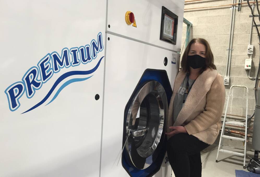NEW TOY: Vicki Lowbridge with the only dry cleaning machine between Wollongong and Ulladulla at the new Shoalhaven Dry Cleaners at South Nowra.