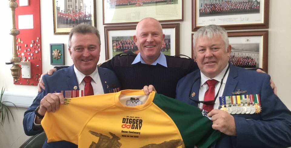 Keith Payne VC Veterans Benefit Group chairman Rick Meehan (left) and vice-chairman Fred Campbell present Royal Hospital Chelsea Regimental Sergeant Major Ross Martin with a Digger Day jersey.