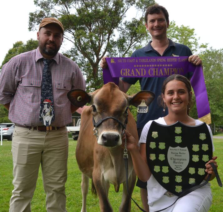 CHAMPION: Grand champion at this year's South Coast and Tablelands Holstein Association Spring Heifer Classic was Rivendell Sentry Cleo shown by Elly Simms being congratulated by judge Pat Buckley (left) and Jared Cochrane of Raine and Horne Nowra.