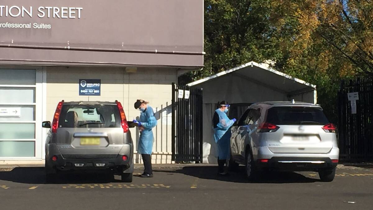 BUSY: Southern IML Pathology staff members undertake COVID tests at Nowra's drive-through clinic.