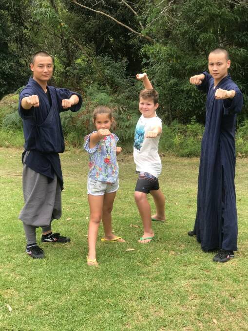 
ON SHOW: Shaolin monks with children at the recent second community information day at Huskisson.
