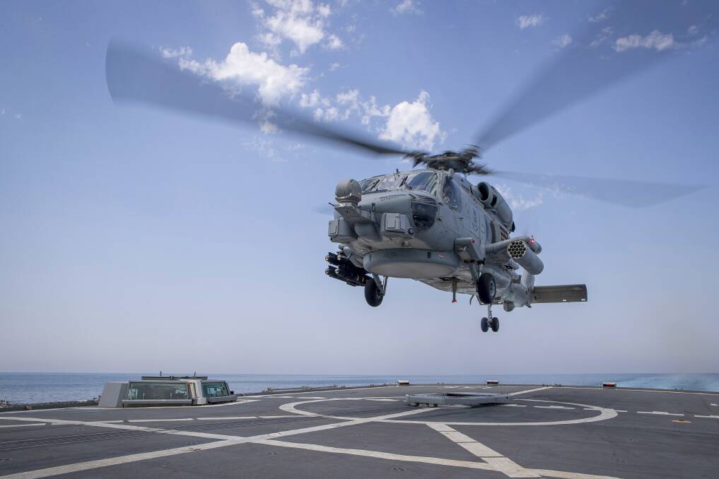 GREAT TOUR: HMAS Toowoomba's embarked MH60-R helicopter 'Nightmare' lands on the ship's flight deck after conducting a patrol in the Straits of Hormuz as part of the International Maritime Security Construct. Photo: Richard Cordell