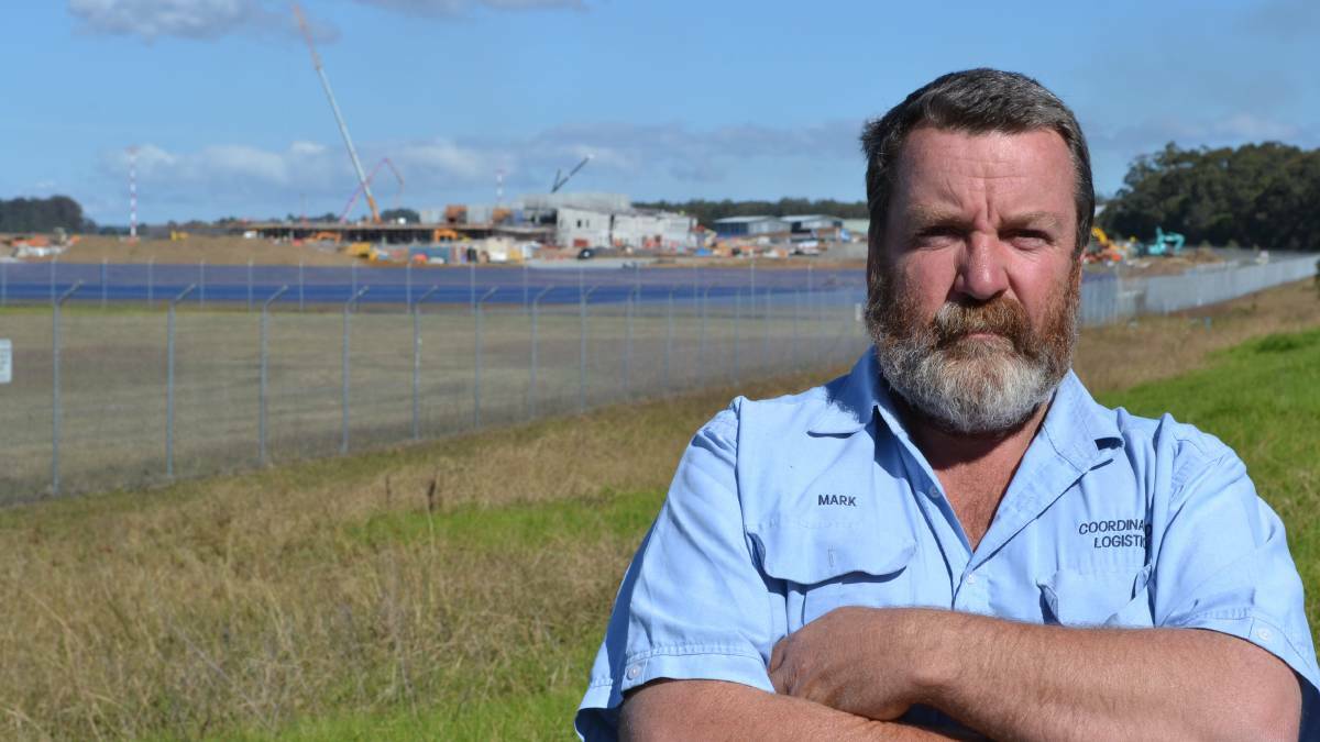 Mark Nelson from Coordinated Logistics near the then uncompleted maintenance and training facilities at HMAS Albatross in May 2014.
