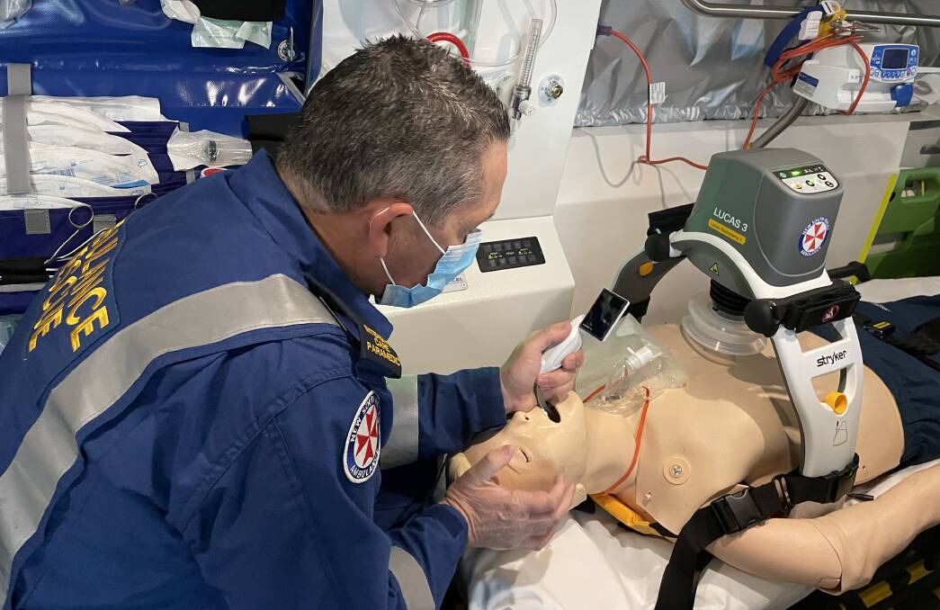 GAME CHANGER: Shoalhaven Special Operation Intensive Care Paramedic Andrew Kinross uses the video laryngoscope for intubation as the Lucas machine caries out mechanical CPR.