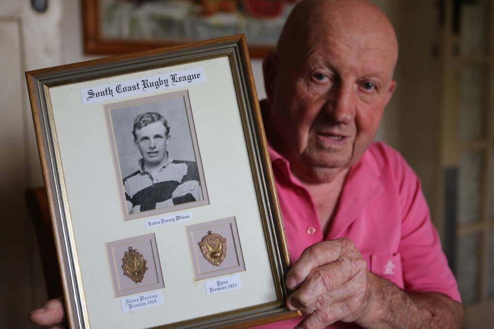 Errol Wilson with a photograph of his father Jim and his rugby league premiership medals of 1919 with the Nowra Warriors and 1925 with the Pyree Rovers.
