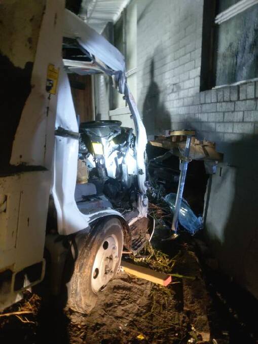 AFTERMATH: The damaged tipper which crashed into a home in Milton on Wednesday night. Image FRNSW Ulladulla