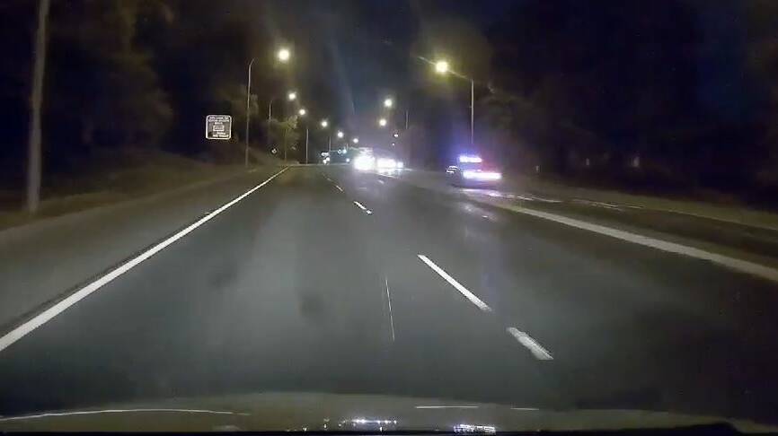 Police pursue the Holden Commodore on the Princes Highway at Nowra. Footage supplied.
