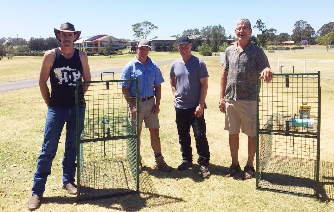 Backing: Shoalhaven Fox Control Project volunteer Rad Tyrrell, Ex-Servicemens Sports Club greenkeeper Tony Webster, contractor shooter Troy Bagnall and Shoalhaven Fox Control Project Coordinator Peter Jirgens with the fox traps donated by Shoalhaven Ex-Services Group.
