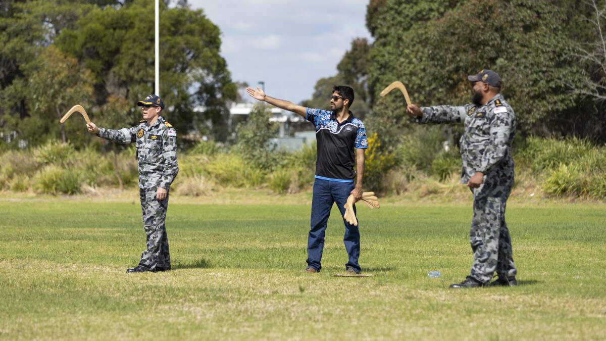 TECHNIQUES: Local Raymond Timbery teaches Royal Australian Navy personnel the technique of throwing a boomerang during a cultural immersion workshop at HMAS Albatross. Photo: Jarrod Mulvihill