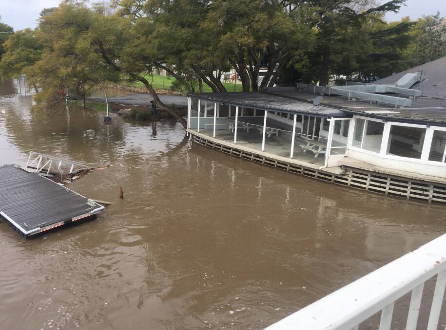 WET: Floodwaters swirl around the former Boatshed Restaurant on the southern bank of the Shoalhaven River at Nowra earlier this month.
