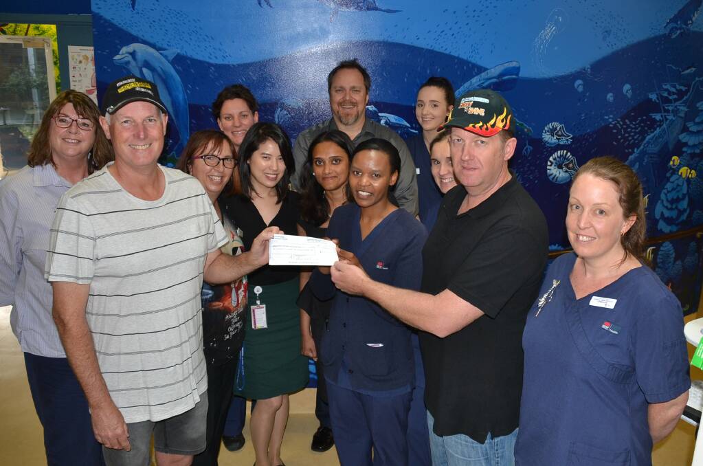 Albatross Show-N-Shine organisers Stu Walters and Glenn Smith present Shoalhaven District Hospital Children’s Ward Nurse Unit Manager Teckler Matutu, Critical Care Operations Manager Stuart Emslie and the rest of the paediatric team with their donation.