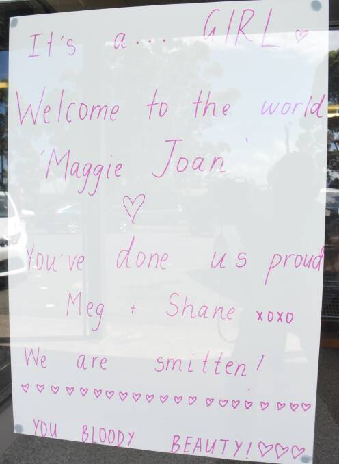 The proud birth announcement in the window of Bakehouse Delights.