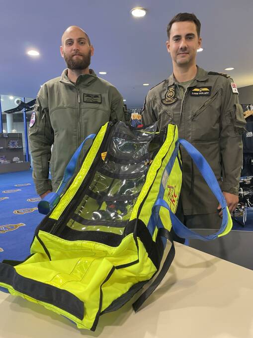FIRST USE: Leading Seaman Aircrewman Michael Bennet (left) and Liam Sulley with one of the Child Rescue Capsules. The Royal Australian Navy only took delivery of the new piece of equipment prior to Christmas and used it recently to airlift two young girls to safety from a flooded house in Sydney.