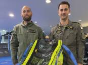 FIRST USE: Leading Seaman Aircrewman Michael Bennet (left) and Liam Sulley with one of the Child Rescue Capsules. The Royal Australian Navy only took delivery of the new piece of equipment prior to Christmas and used it recently to airlift two young girls to safety from a flooded house in Sydney.