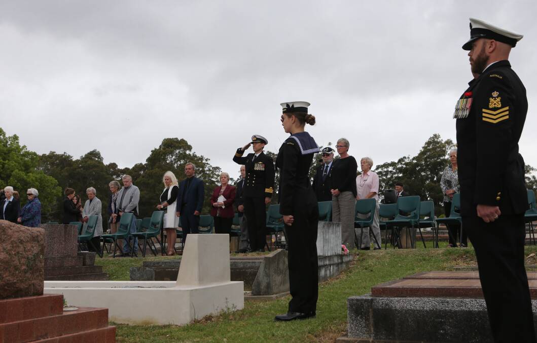 RESPECT: HMAS Albatross Executive Officer Commander Nigel Rowan.and personnel from the Nowra base stand to attention as the Last Post is played during Wednesday morning's war grave rededication.
