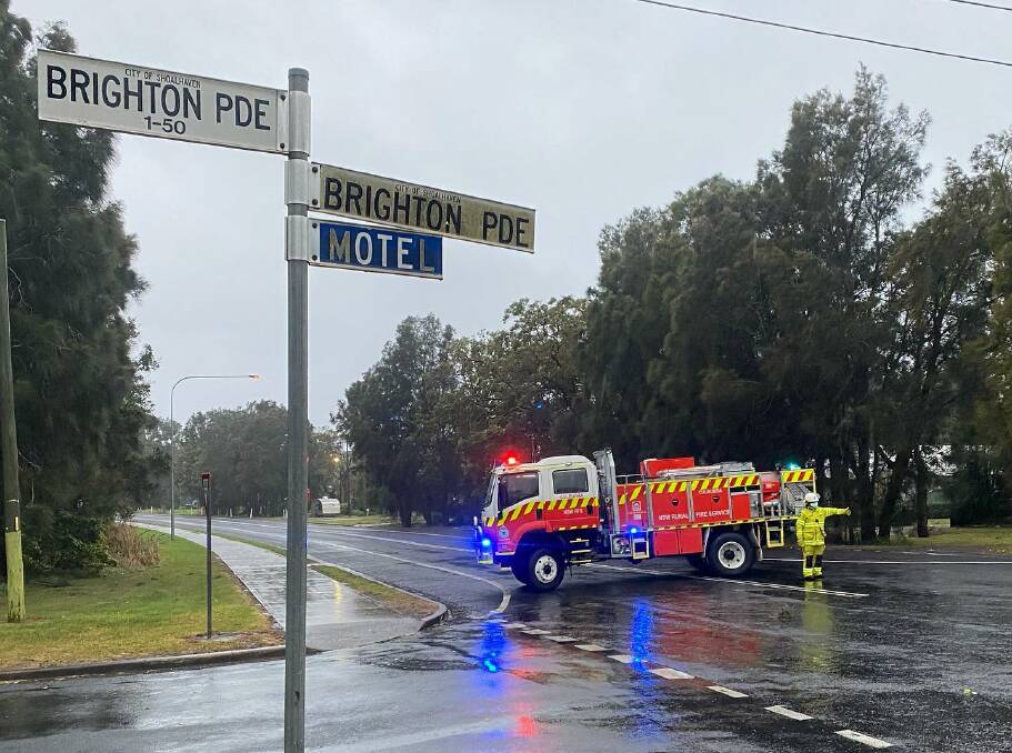 EMERGENCY: Culburra Beach Rural Fire Service personnel direct traffic around Prince Edward Avenue on Tuesday afternoon, which was closed in both directions between Brighton Parade and Eastwood Avenue due to powerlines being down. 