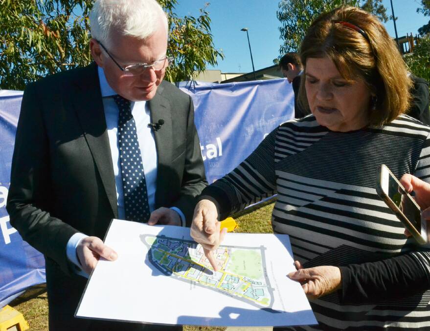 Kiama and South Coast MPs Gareth Ward and Shelley Hancock look over the proposed master plan for Shoalhaven District Hospital.