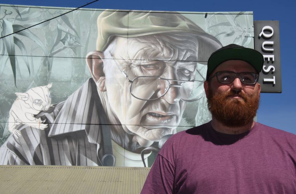World renowned, Nowra born artist, Smug with his mural of local artist George Sobierajski on the Quest building in the Nowra CBD.