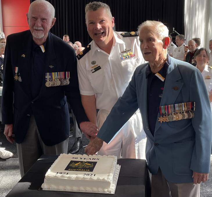 HONOUR: Bob Brown (left) and Rusty Marquis cut a special 50th anniversary cake, with the RAN's latest Warrant Officer Royce De Strang.