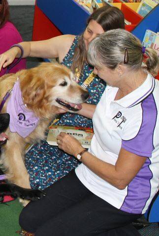 GREAT MATES: Bear and his owner Dawn Spicer during a visit for the Paws 'n' Tales program at the Nowra Library