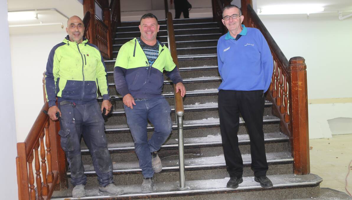 NEW LOOK: Ralph Rugiano and Maurice Bertapelle, of Iconic Property Holdings, part of the Iconic Group, who are undertaking the buildings makeover, on the ornate staircase with Les Bryant who worked at the building for 35 years during its Woodhills, Mates, Emmotts, Young's and finally Grace Bros days.