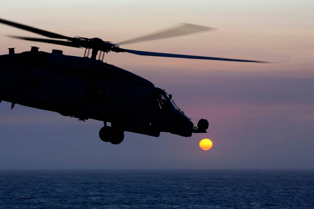 STUNNING: HMAS Canberra's embarked MH60-R Maritime Combat Helicopter flying during Exercise Ocean Explorer 2019.  Photo: Kieren Whiteley 