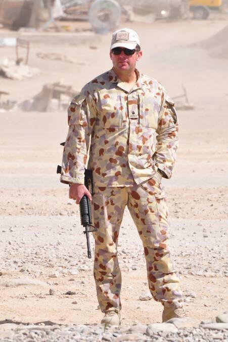 Glenn Kolomeitz, a lawyer and former soldier who served in Afghanistan and East Timor, on deployment (above and below).