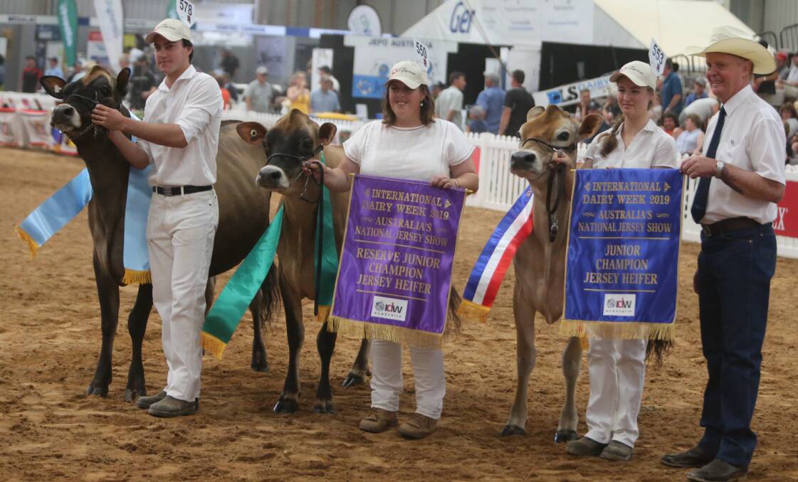 Hayley Menzies, of Rivendell Jerseys, Numbaa (centre) claimed reserve junior champion Jersey with Rivendell Getaway Rose.