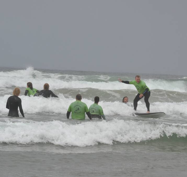 ON A WAVE: Rick Meehan catches a wave as part of the Veterans Surfing Program.