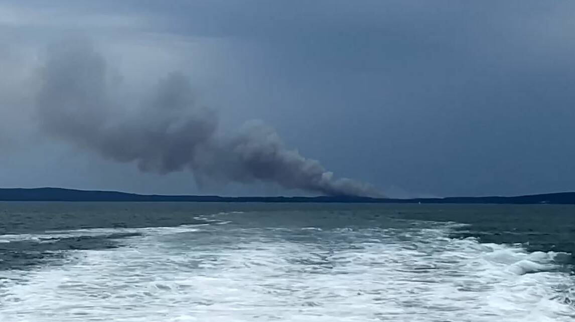 MASSIVE PLUME: The fire in the Booderee National Park at Jervis Bay is throwing up a massive plume of smoke. Image: Scott Sheehan